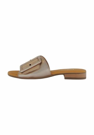 Flat slide sandal with a metallic rose gold upper, large buckle accent, and a tan footbed. Minimalist design with a low, wooden heel.