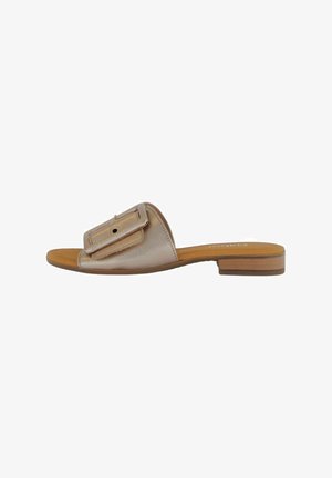 Flat slide sandal with a metallic rose gold upper, large buckle accent, and a tan footbed. Minimalist design with a low, wooden heel.