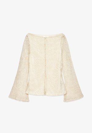 Crème lace blouse met bell sleeves, ingewikkelde bloemmotieven en een knoopsluiting aan de achterkant. Lichtgewicht, textuurdesign van stof.