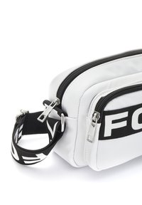 White synthetic bag with dual zippers, black strap featuring white logo, rectangular shape, and textured accents on the surface.