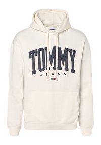 Krémová mikina s kapucí s velkým námořnickým logem "TOMMY" a textem "JEANS" níže, s přední kapsou a ribbenými manžetami.