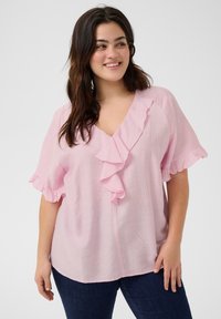 Blusa rosa chiaro con scollatura a righe e maniche corte, realizzata in tessuto morbido. Design a V con una vestibilità comoda, abbinata a jeans scuri.