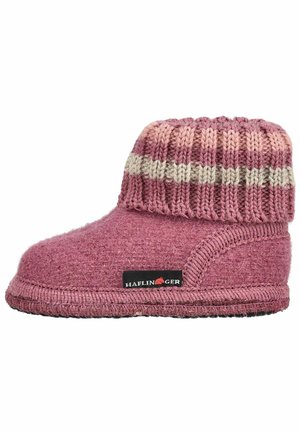 Chausson en laine rose douce avec un revers tricoté plié présentant des rayures roses et beiges et une petite étiquette noire sur le côté.