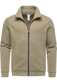 Giacca beige con zip e colletto alto, realizzata in tessuto morbido. Presenta tasche laterali e polsini e orlo a coste. Dettaglio della zip robusta.