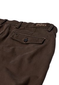 Dark brown pants made from soft fabric featuring a back pocket with a black button and a stitched label with the word "gallery."