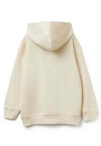 Krémová mikina s kapucí a volným střihem, s ribbovanými manžetami a dolním lemem, jemnou texturou a bez viditelných grafik nebo vzorů.