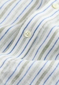 Striped shirt featuring white fabric with narrow green and blue stripes, lightweight texture, and round buttons with a four-hole design.