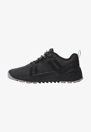 Black low-top athletic sneaker with textured knit upper, thick rugged sole, lace-up front, and pull tab at heel.