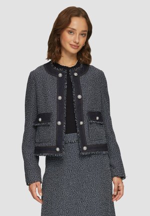 Navy tweed jacket with frayed edges, round neckline, front pockets, and silver-tone button closures. Textured fabric with a structured fit.