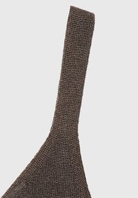 Brown knitted bra with a textured fabric, featuring a wide shoulder strap and a triangular shape. The design is minimal and seamless.