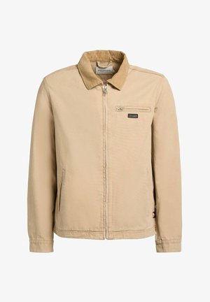 Beige jas met ritssluiting, corduroy kraag, twee zakken aan de voorkant en een klein ritssluitvakje op de rechterborst.