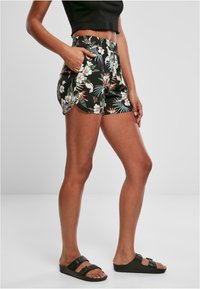 Blommiga shorts med elastisk midja i svart, med tropiska mönster av blad och blommor. Sidofickor och avslappnad passform.