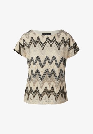 Korte mouwtop in beige met een zwart en grijs zigzagpatroon. Stof heeft een gestructureerde uitstraling. Ronde halslijn en getailleerde pasvorm.