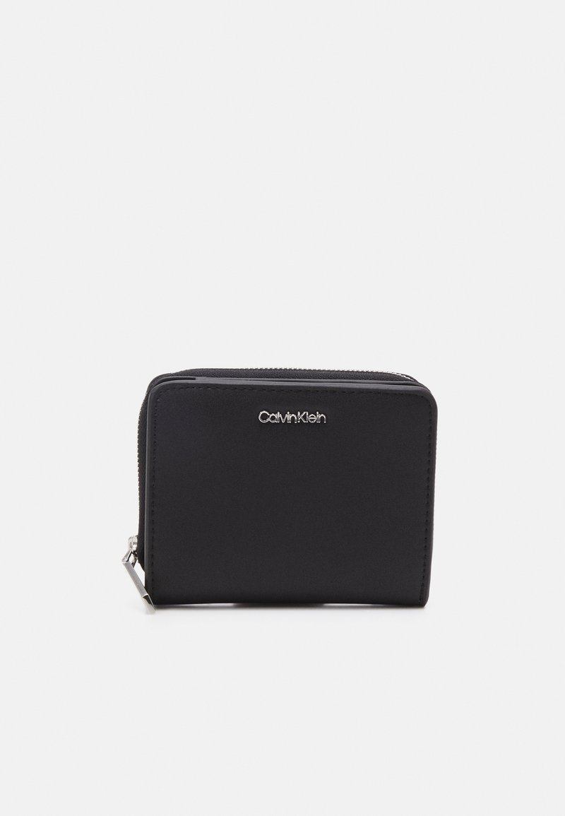 Black zippered wallet made of smooth material. Features a silver logo on the front and a sleek rectangular shape with rounded edges.
