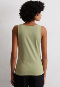 Olive green sleeveless top made of soft fabric, featuring a rounded neck and a relaxed fit, shown from the back with light texture details.