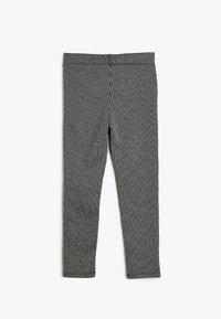 Mustat ja valkoiset ruutukuosiset leggingsit, joissa on joustava kangas ja sileä pinta sekä vyötärönauha. Sivusaumat näkyvissä, ei taskuja.