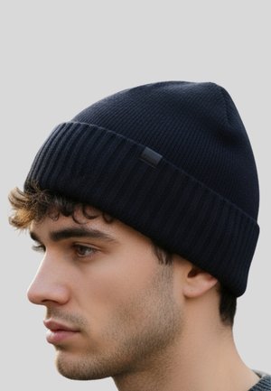 Navy blue knit beanie with a ribbed design and a small logo patch. Soft texture, fitted shape, suitable for cold weather.