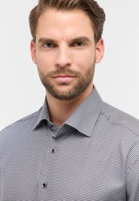 Blauw-witte gestreepte button-up overhemd met een spread collar, voorzien van donkere knopen en een gestructureerde stof.