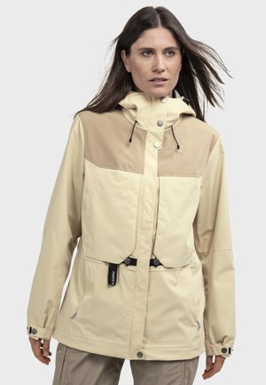 Light beige waterproof jacket with a tan upper section, adjustable hood, two front pockets, and black hardware accents. Features a cinched waist.