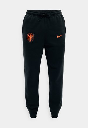Mustad dressipüksid oranži Holland jalgpallimeeskonna vapiga vasakul reiel ja Nike logoga paremal reiel, elastse vöökohaga ja nööriga.