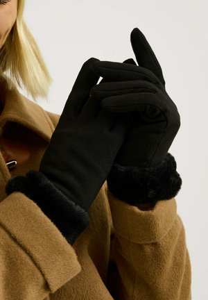Gants noirs avec un extérieur doux et des poignets en fausse fourrure noire texturée. Les gants ont un design ajusté et une finition lisse, adaptés aux temps froids.