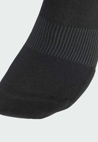Black sock with a ribbed upper band and smooth textured body. The toe and heel areas have a reinforced design for durability.