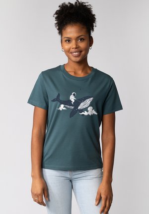 Teal cotton t-shirt featuring a graphic of an astronaut riding a whale, with clouds and stars in the design, casual fit and round neckline.