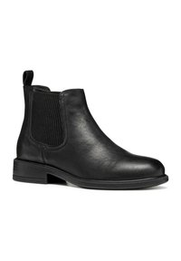 Botín Chelsea de cuero negro con paneles laterales elásticos, puntera redondeada, tacón bajo y una lengüeta para facilitar el calzado. Textura suave con un detalle mínimo.