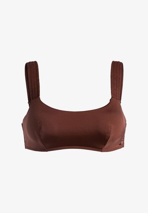 Brązowy biustonosz z elastycznej tkaniny z szerokimi, strukturalnymi ramiączkami i gładkim wykończeniem. Bez fiszbin, z bezszwowym designem.