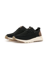 Zapatillas de malla negras con acentos en marrón, punta redonda y suela de goma blanca contrastante. Cuenta con cordones y una tira en el talón para facilitar su uso.