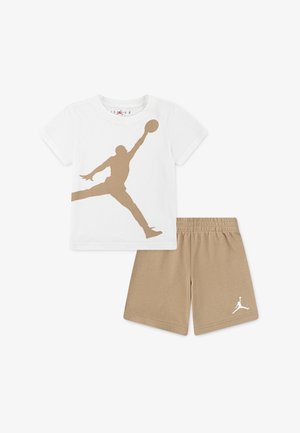 White cotton t-shirt with a golden basketball silhouette, paired with beige shorts featuring a white logo on the hem.