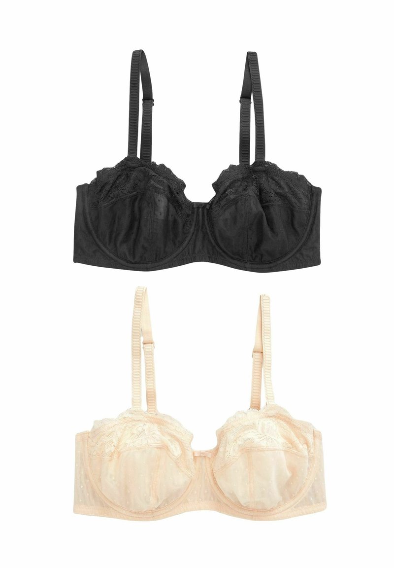 Reggiseno in pizzo nero con ferretto e spalline regolabili sopra un reggiseno in pizzo beige con pois e dettagli arricciati. Entrambi presentano coppe trasparenti.