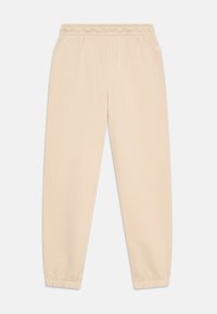 Pantaloni de trening bej cu talie elastică și tiv cu manșetă, confecționați dintr-un material moale, aranjați plat pe un fundal alb.
