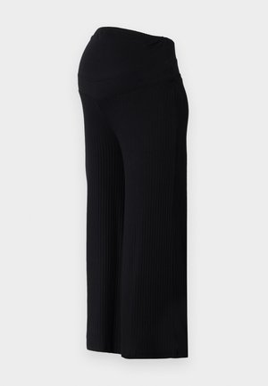 Mustad ridged laiad säärised kõrge taljejoonega. Kanga pind on sile ja veniv, pakkudes lõdvestunud istuvust üle kogu säärte.