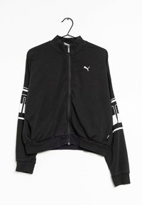 Giacca a track nera con zip e colletto alto, caratterizzata da strisce bianche sulle maniche e un piccolo logo bianco sul petto. Tessuto morbido ed elastico.