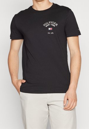 Black cotton t-shirt featuring the text "HILFIGER NEW YORK" and a small logo, accented with red and white details, classic crew neck design.
