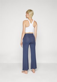Yogasearcher JAIPUR FLARE PANTS - Tracksuit bottoms - navy