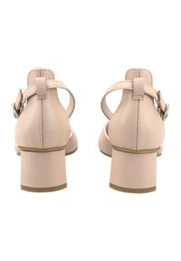 Beige leather block-heeled shoes with an adjustable ankle strap, smooth texture, and a rounded toe design.