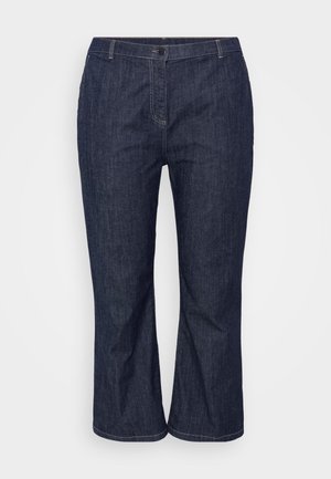 Tumedat sinised teksapüksid sirge lõikega, millel on ees nööpide sulgemine, vööde jaoks silmused ja peened õmblused õmbluste ääres.