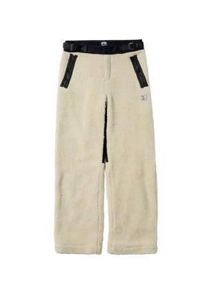 Krémové fleecové kalhoty s měkkou texturou, které mají černý nastavitelný pas a přední kapsy na zip.