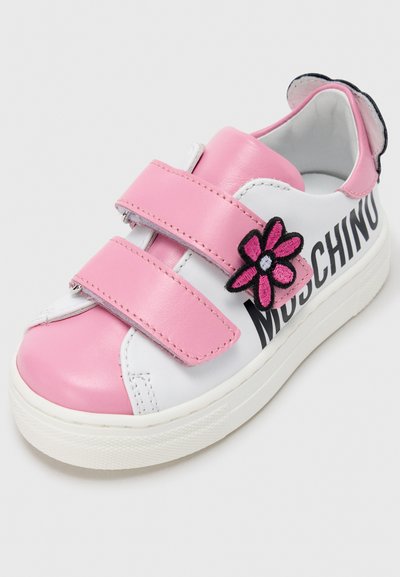 Άσπρο αθλητικό παπούτσι με ροζ δερμάτινες λεπτομέρειες, δύο λουριά με βέλκρο, μαύρο λογότυπο "Moschino" και κεντημένο ροζ λουλούδι.