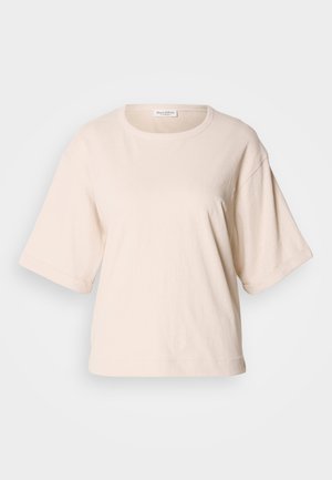 T-shirt à manches courtes beige clair, fabriqué en coton doux. Doté d'un col rond et d'une coupe oversized avec des manches retroussées. Design minimaliste.