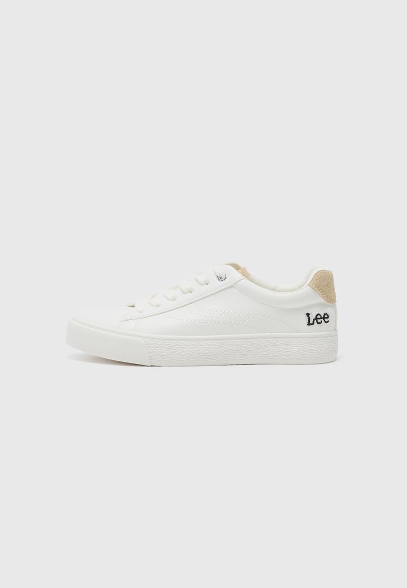 White leather sneaker with textured rubber sole, round toe, and lace-up front. Features a beige suede heel tab and embroidered "Lee" logo.