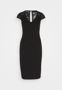Robe noire mi-longue aux genoux avec manches courtes en dentelle, encolure en V et détail en dentelle dans le haut du dos, silhouette ajustée et petite fente à l'avant.