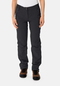 Pantaloni leggeri neri da esterno con una texture liscia, tasche con zip e vita aderente. Presentano ginocchia articolate per una maggiore mobilità.