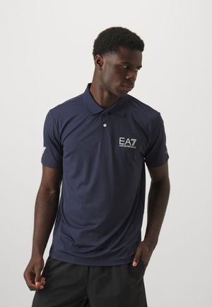 Navy polo shirt made of smooth, breathable fabric. Features a collar, short sleeves, and an EA7 logo embroidered on the chest.
