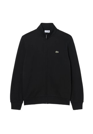 Schwarze Jacke mit durchgehendem Reißverschluss, gerippten Bündchen und Saum, hohem Kragen und kleinem grünem Krokodil-Logo auf der linken Brust.
