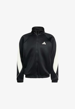 Veste zippée noire avec un col montant, panneaux latéraux blancs et un logo en relief sur la poitrine. Fabriquée dans un matériau lisse et léger.