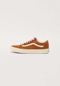 Suede sneakers in orange-brown with white accents. Low-top design, round toe, flat laces, and a rubber sole. Classic side stripe detail.