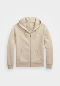 Beige zip-up hoodie with a drawstring hood, two front pockets, and a small embroidered logo on the left chest. Soft fabric texture.